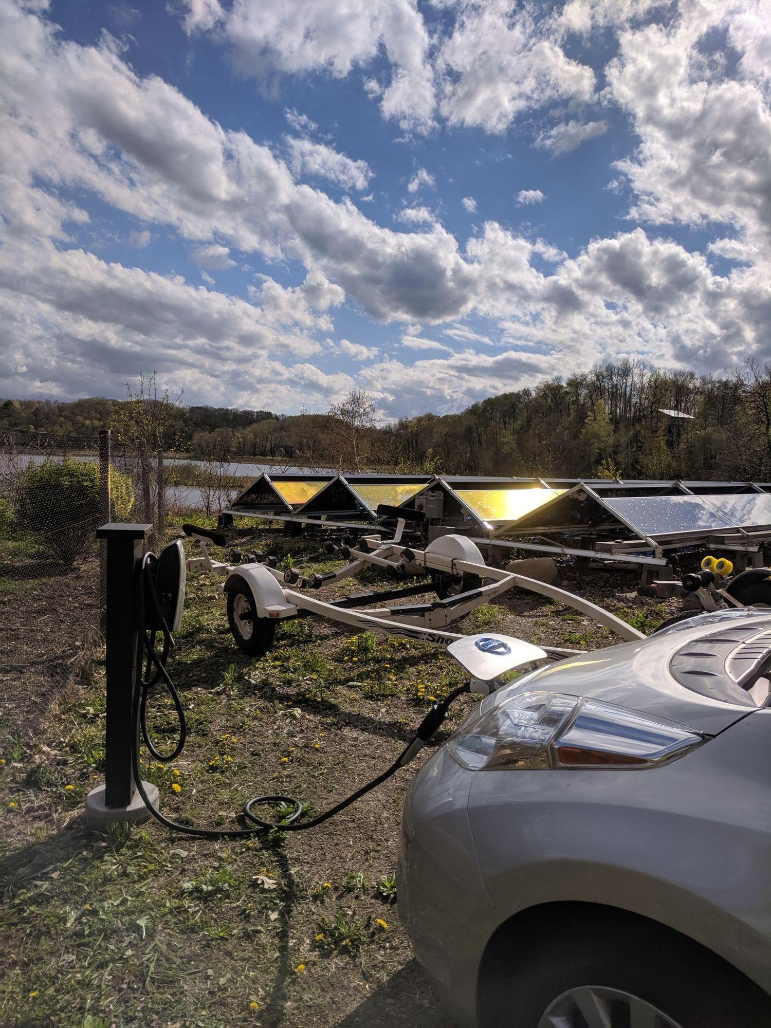 Leaf plugged in with adapter charging on solar power.