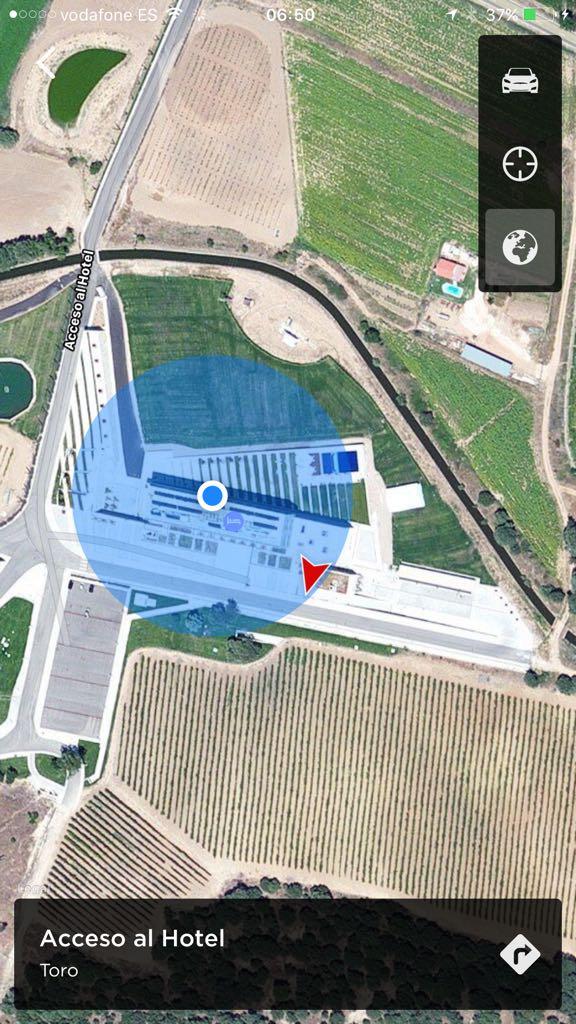 The two Tesla Wall Connectors are near the entrance to the garage, which is found by doubling back at the end of a ramp down from reception.  Watch out for the bottom of your car on the way down the ramp!