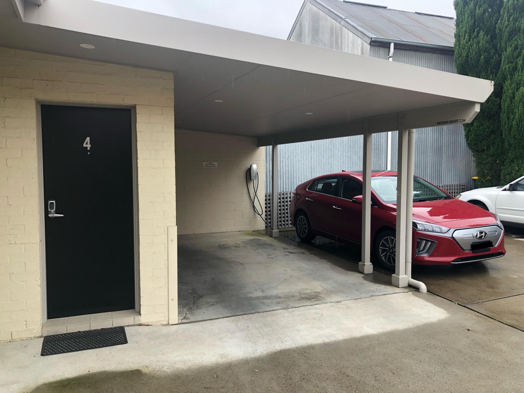The un-locked Tesla Destination Charger is next to Apartment #4. Call ahead for permission.