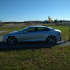 Tesla charger is around back. It is 64 amps and just a single charger.