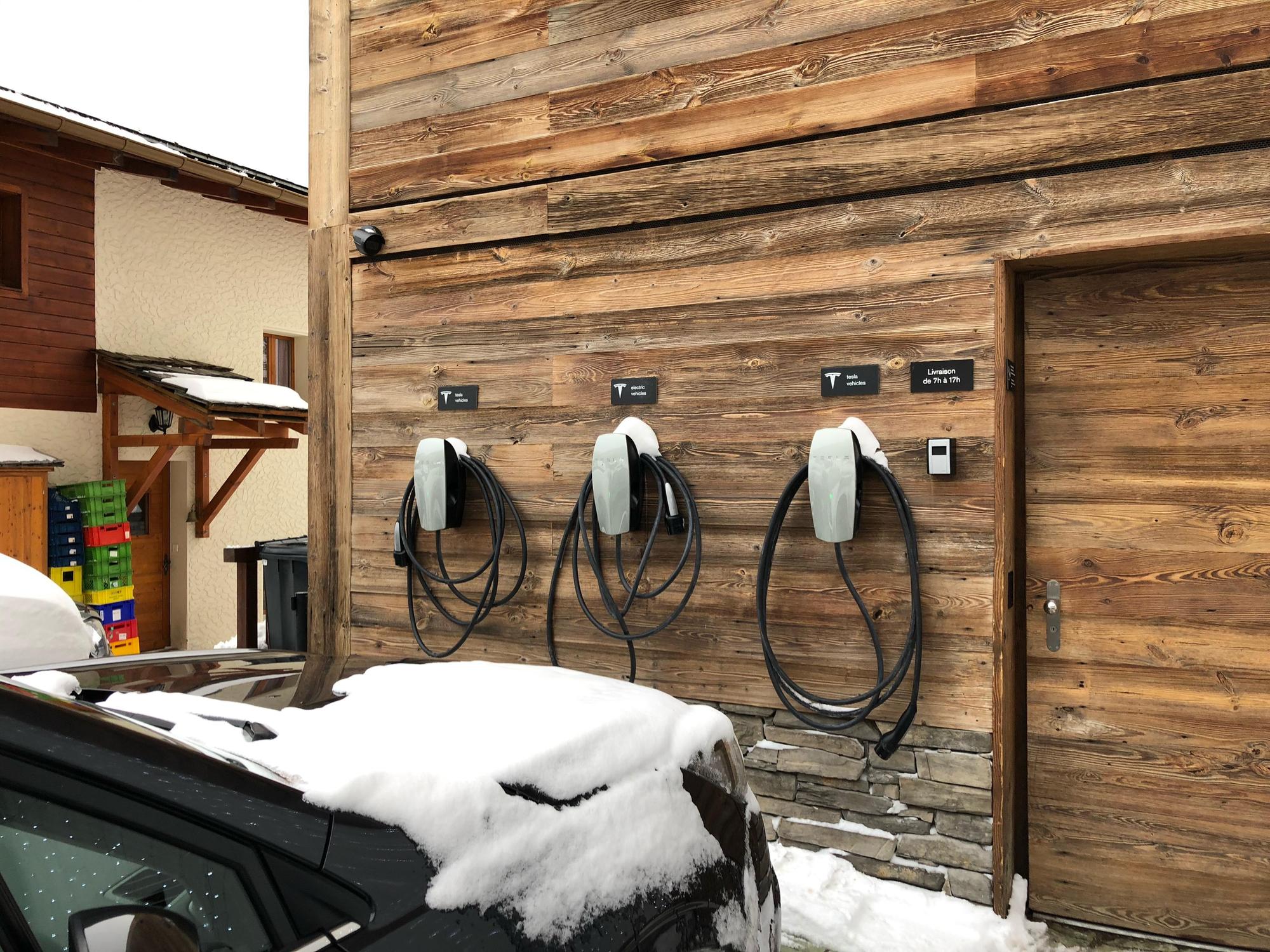 3 bornes de recharge TESLA contre la façade de l’hôtel.